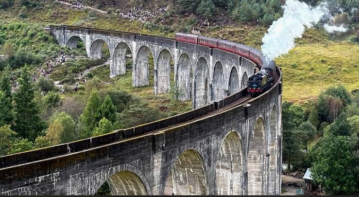 The Jacobite steam train crossing the stone arches of Glenfinnan Viaduct
